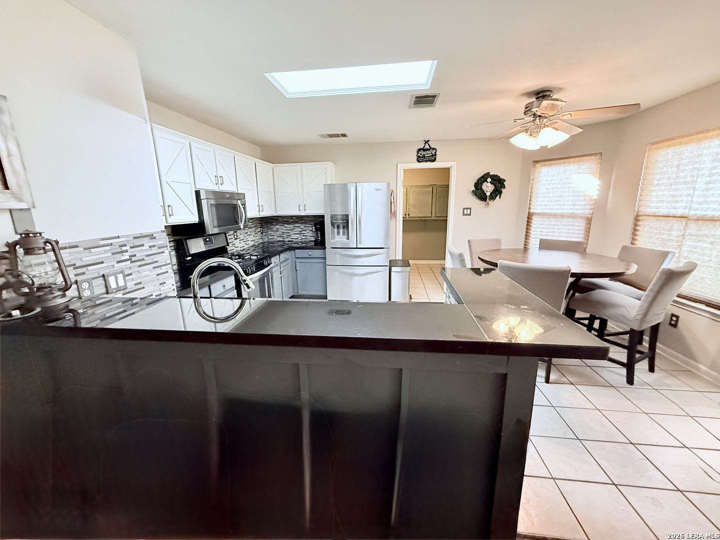 13916 Randalstone Drive Pflugerville, TX 78660 - Photo 10 of 32 a kitchen with a sink cabinets and window