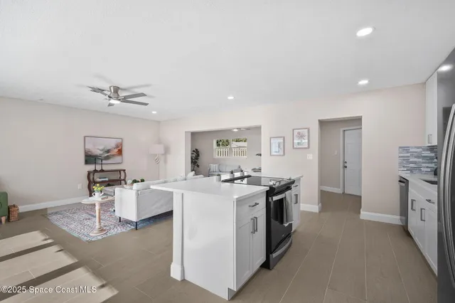 a kitchen with stainless steel appliances a stove a sink dishwasher and a refrigerator