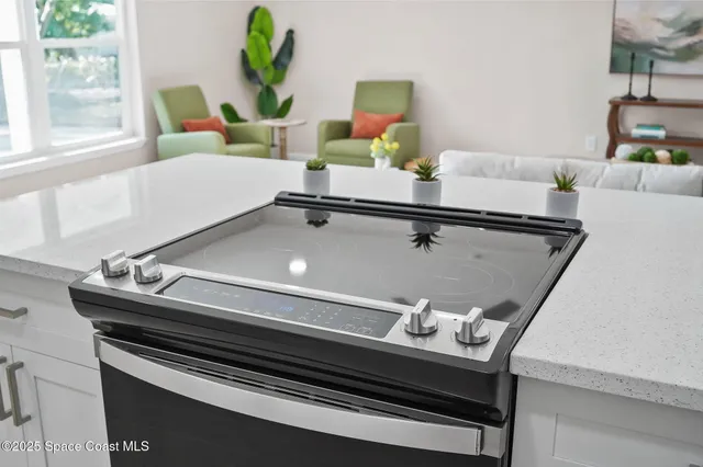 a room with a table chairs and windows