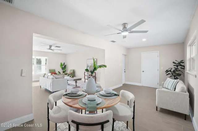 a dining room with furniture and wooden floor