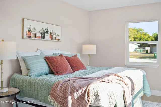 a bedroom with a bed and a painting on the wall