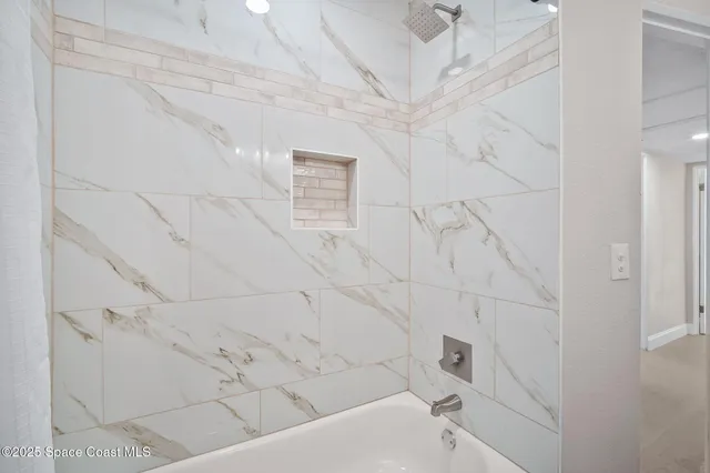 a bathroom with a bathtub and shower