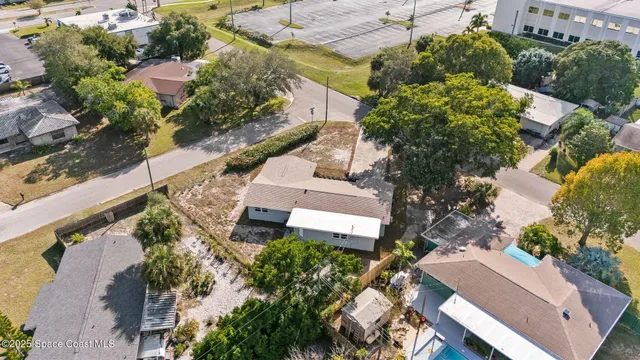an aerial view of multiple houses with yard