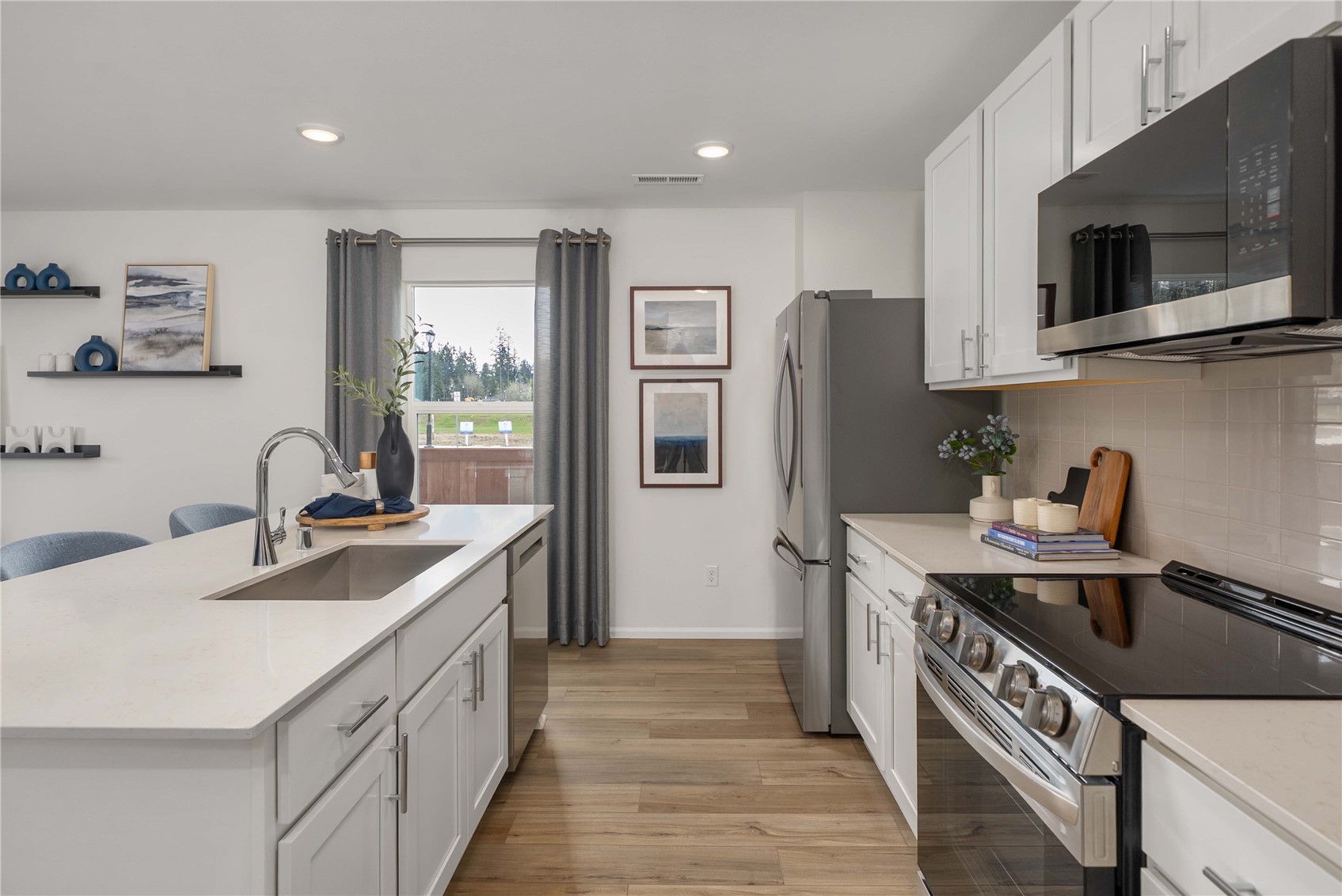 13411 324th Avenue Southeast Sultan, WA 98294 - Photo 10 of 23 a kitchen with stainless steel appliances granite countertop a sink stove and refrigerator
