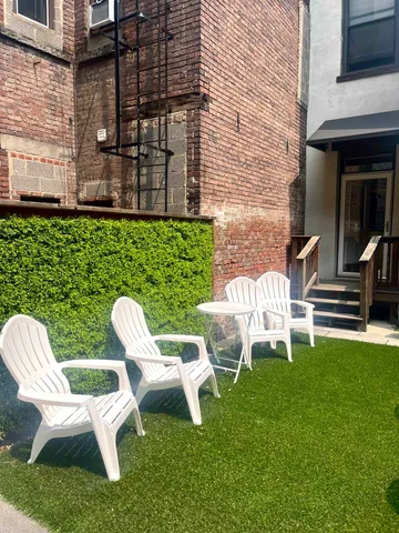 a couple of chairs sitting in front of a building