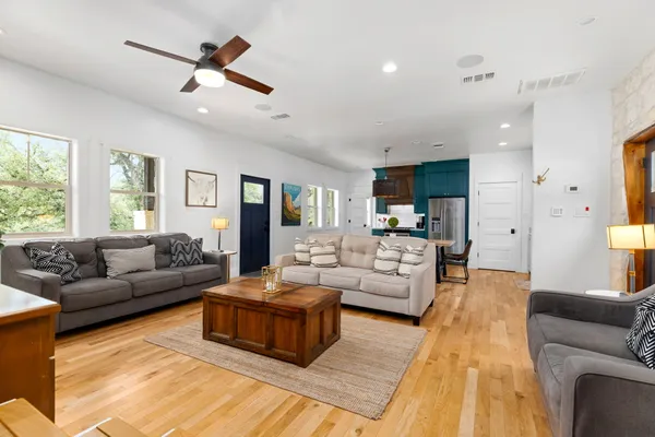 a living room with furniture and view of kitchen