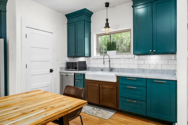 a kitchen with a sink cabinets and window