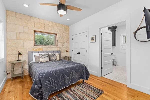 a bedroom with a bed and wooden floor