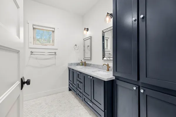 a bathroom with a granite countertop sink a mirror and a vanity