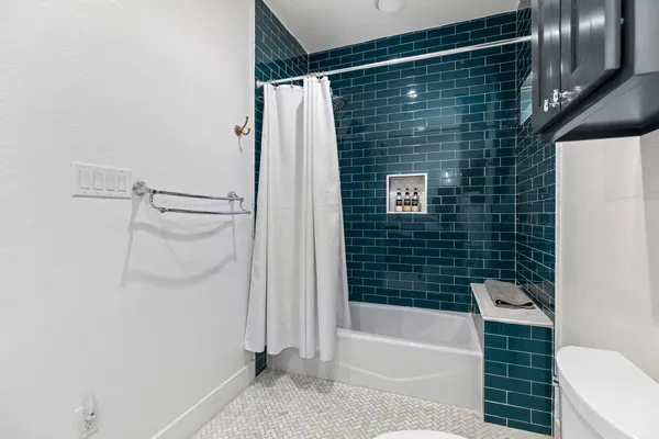 a bathroom with a shower and a sink