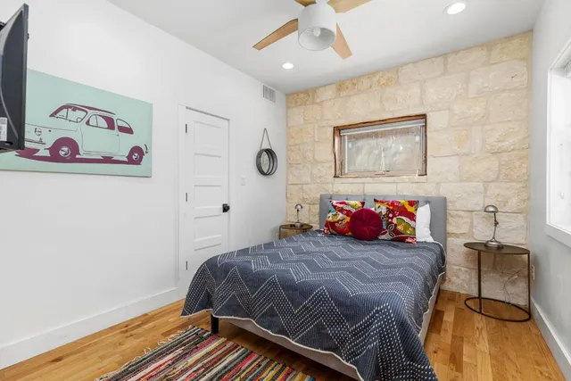 a bedroom with a bed and a window