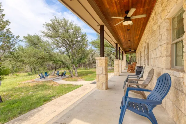 a view of a patio with couches chairs and a big yard