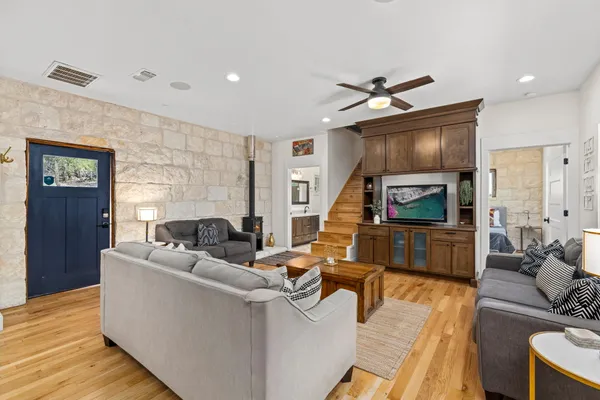 a living room with furniture and a wooden floor