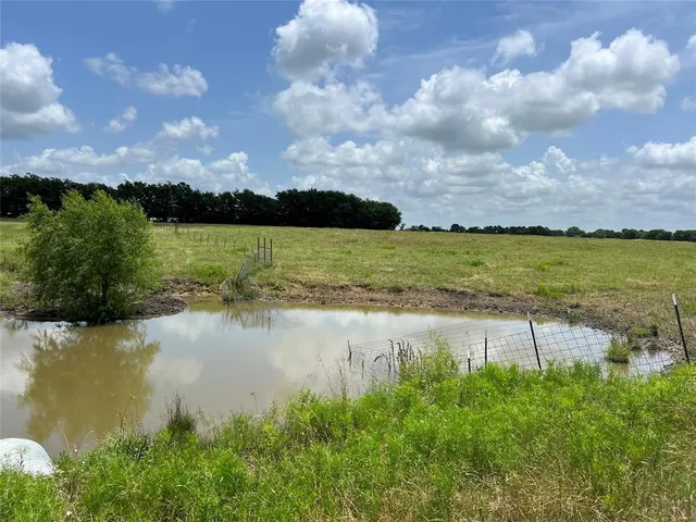 an aerial view of a residential houses with outdoor space and ocean view