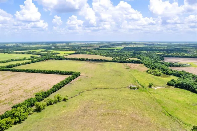 a backyard of a house with lots of green space table and chairs
