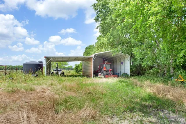 a view of yard with grass & street