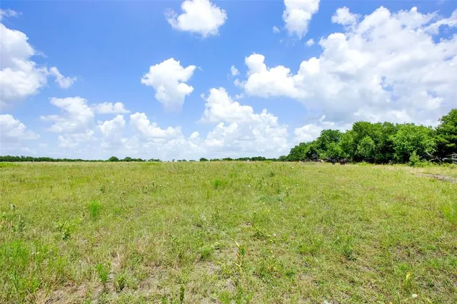 a view of a swimming pool and an outdoor seating