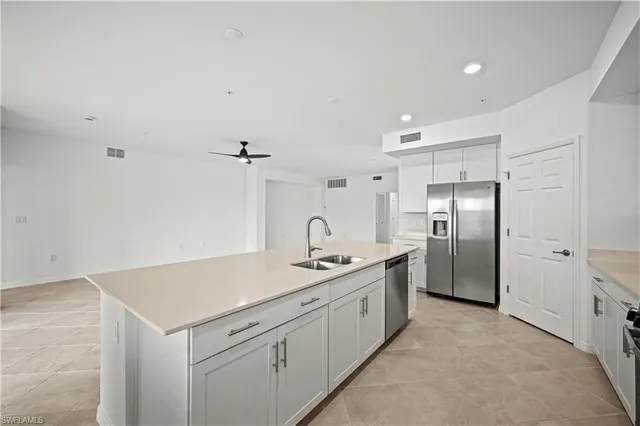 a kitchen with a refrigerator and a sink