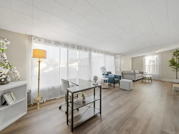 a living room with furniture and wooden floor