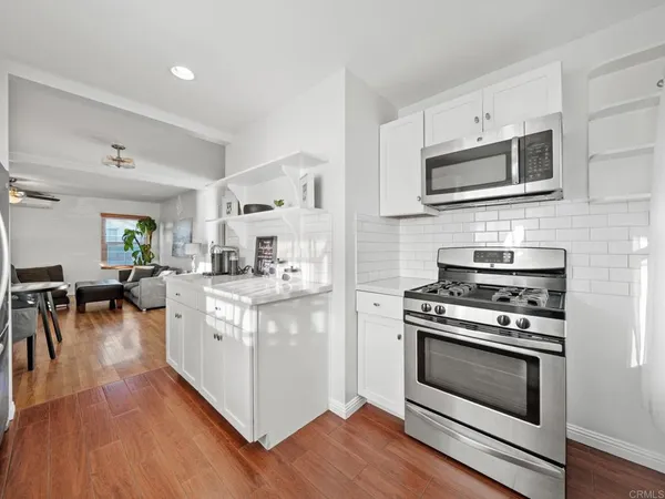 a kitchen with stainless steel appliances a stove microwave and cabinets