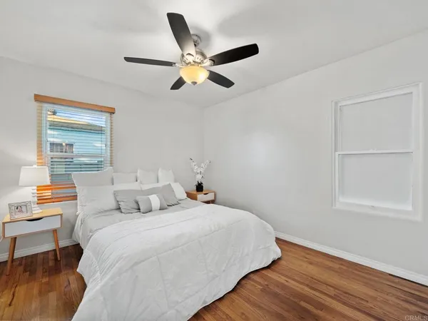 a bedroom with a bed and a large window