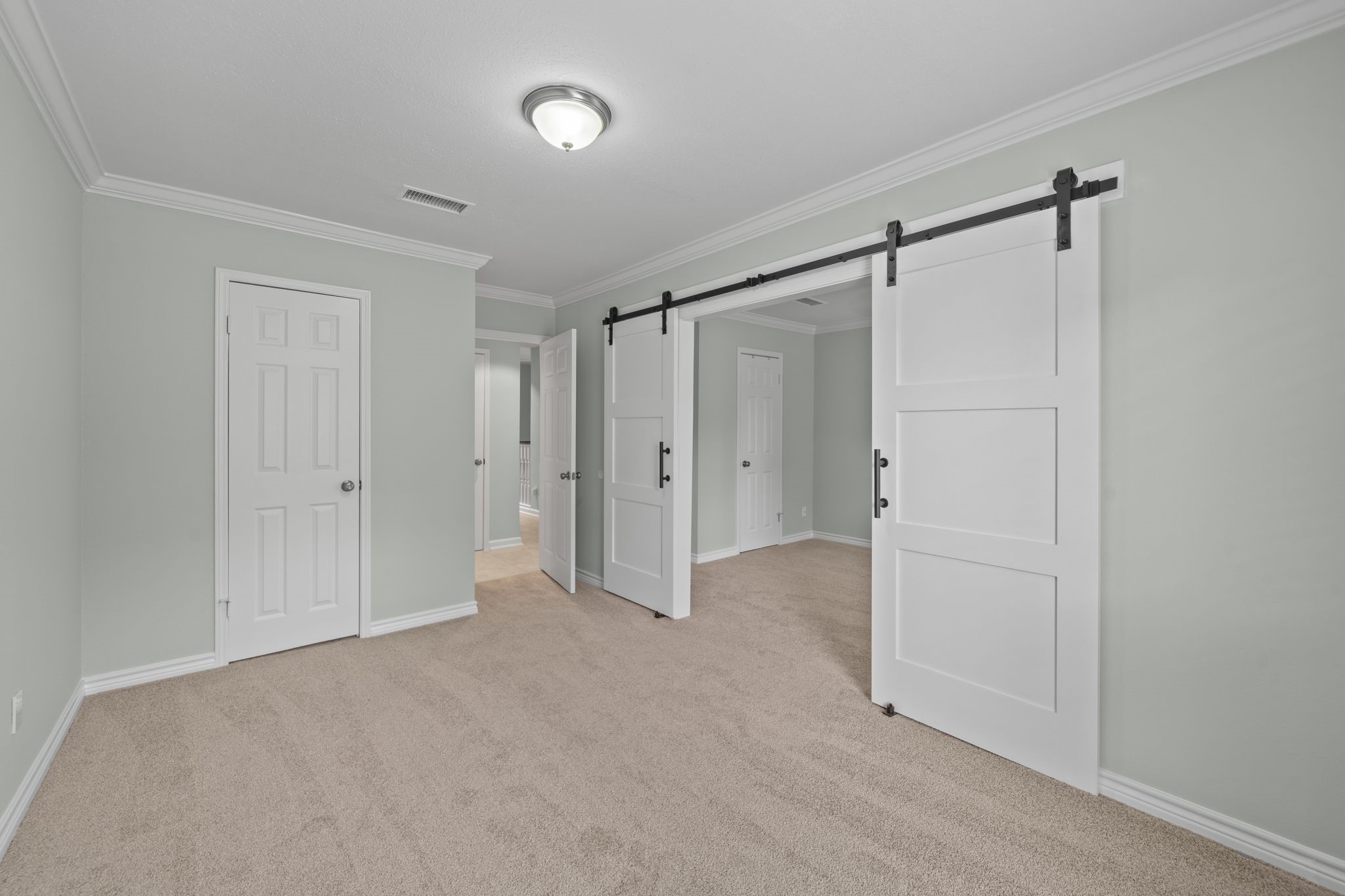 5801 Lumberdale Road, Unit 132 Houston, TX 77092 - Photo 17 of 33 Custom barn doors separate the bedrooms
