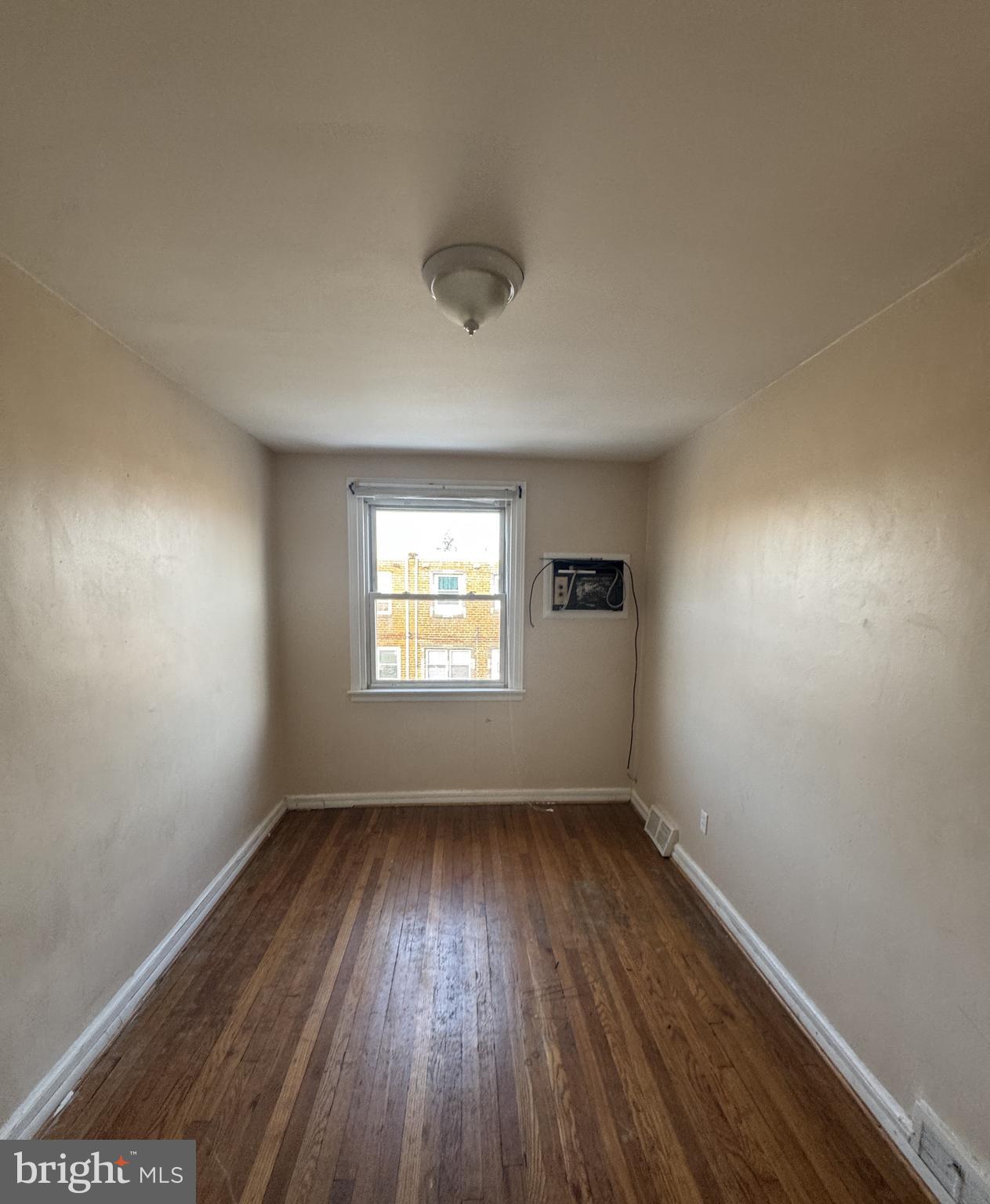 6048 Agusta Street Philadelphia, PA 19149 - Photo 12 of 24 an empty room with wooden floor and windows