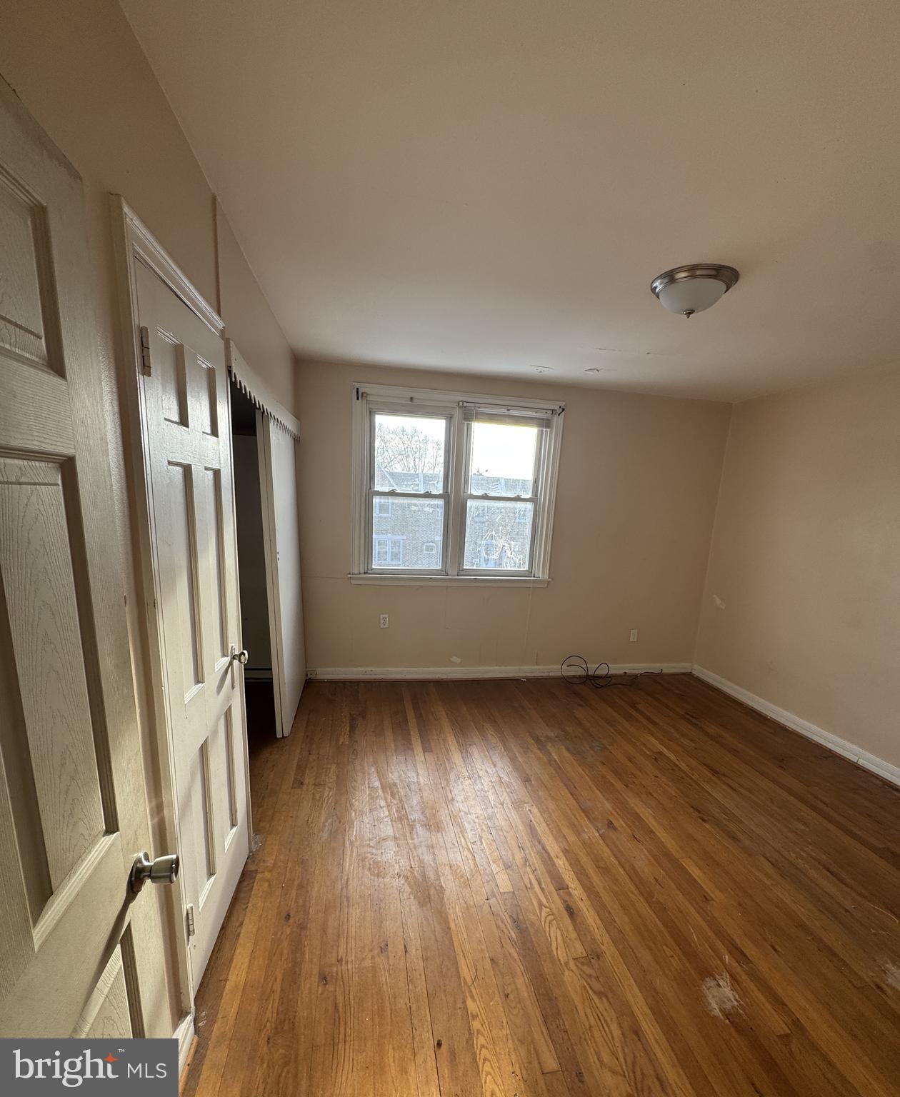 6048 Agusta Street Philadelphia, PA 19149 - Photo 16 of 24 a view of an empty room with wooden floor and a window