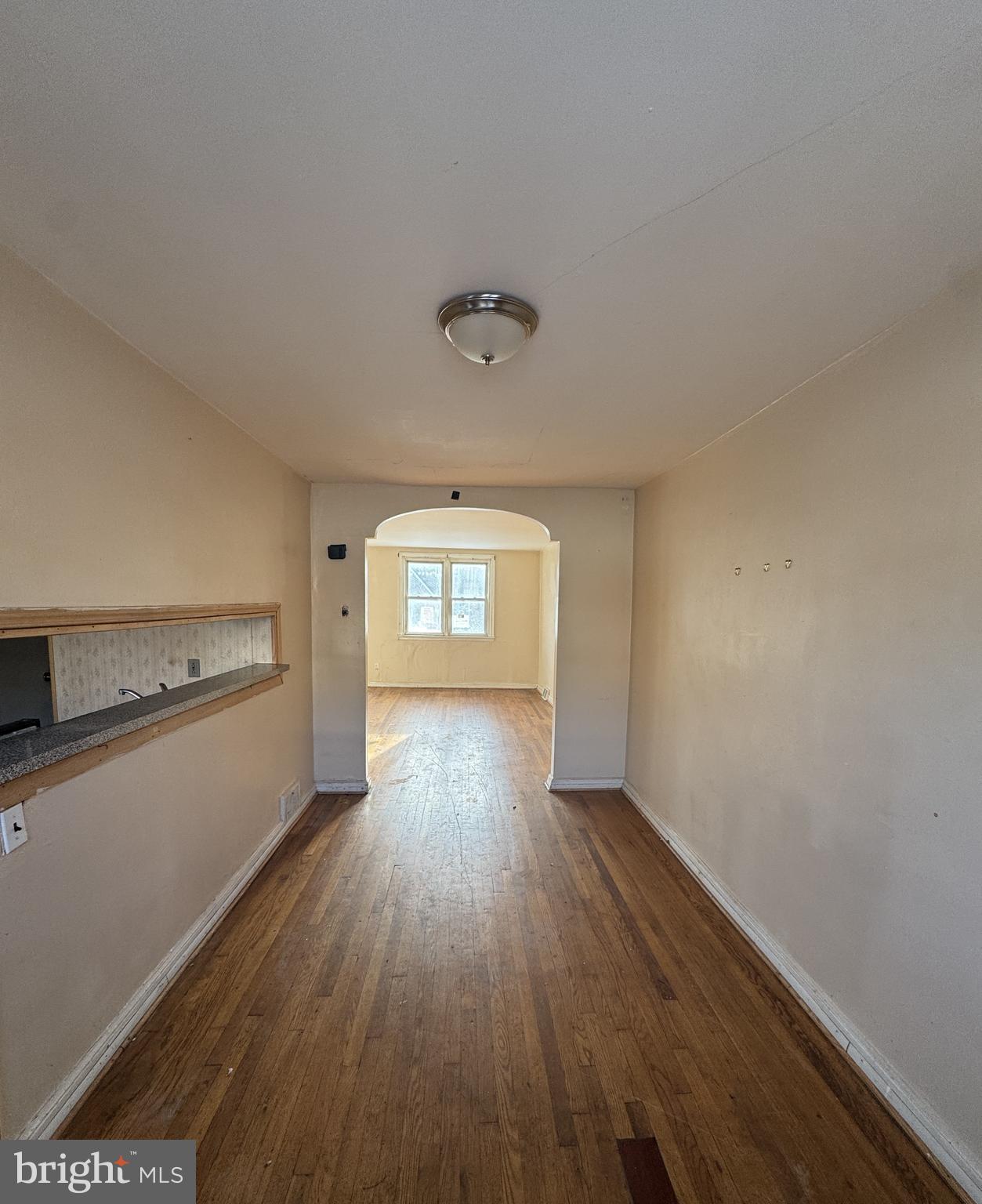 6048 Agusta Street Philadelphia, PA 19149 - Photo 5 of 24 a view of empty room with wooden floor and fan