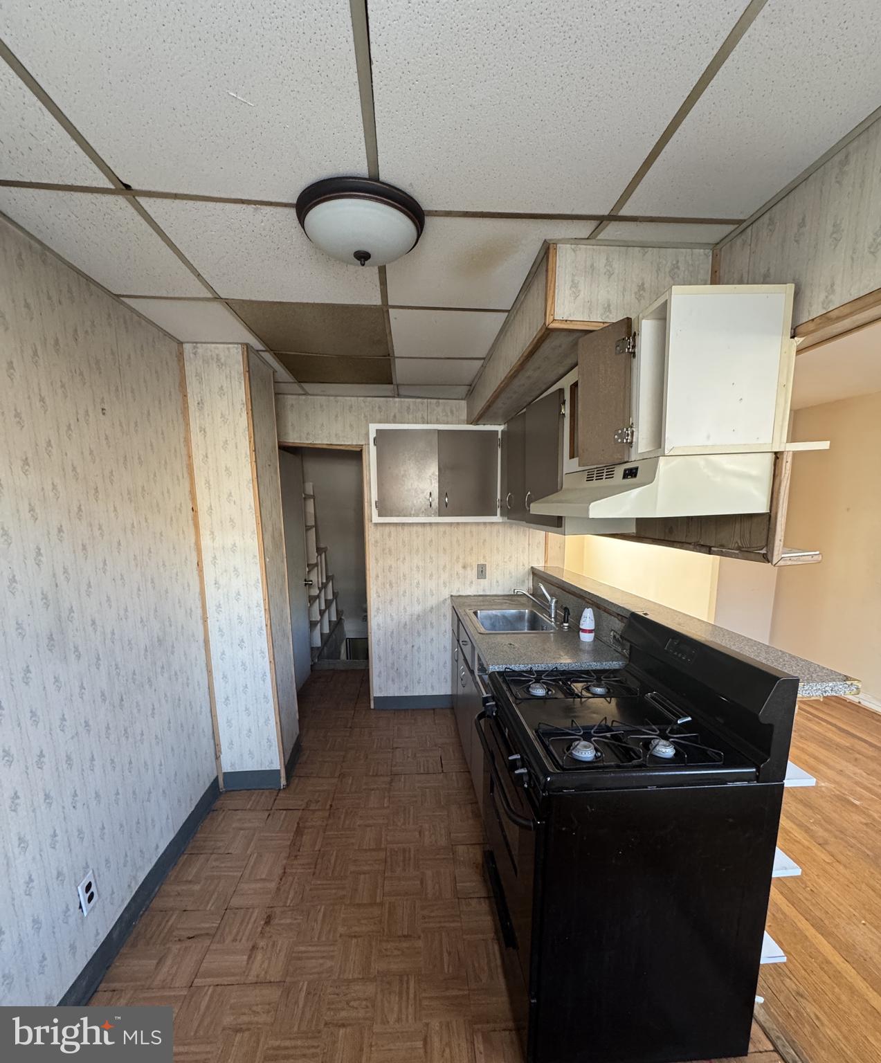 6048 Agusta Street Philadelphia, PA 19149 - Photo 6 of 24 a kitchen with a stove and a refrigerator