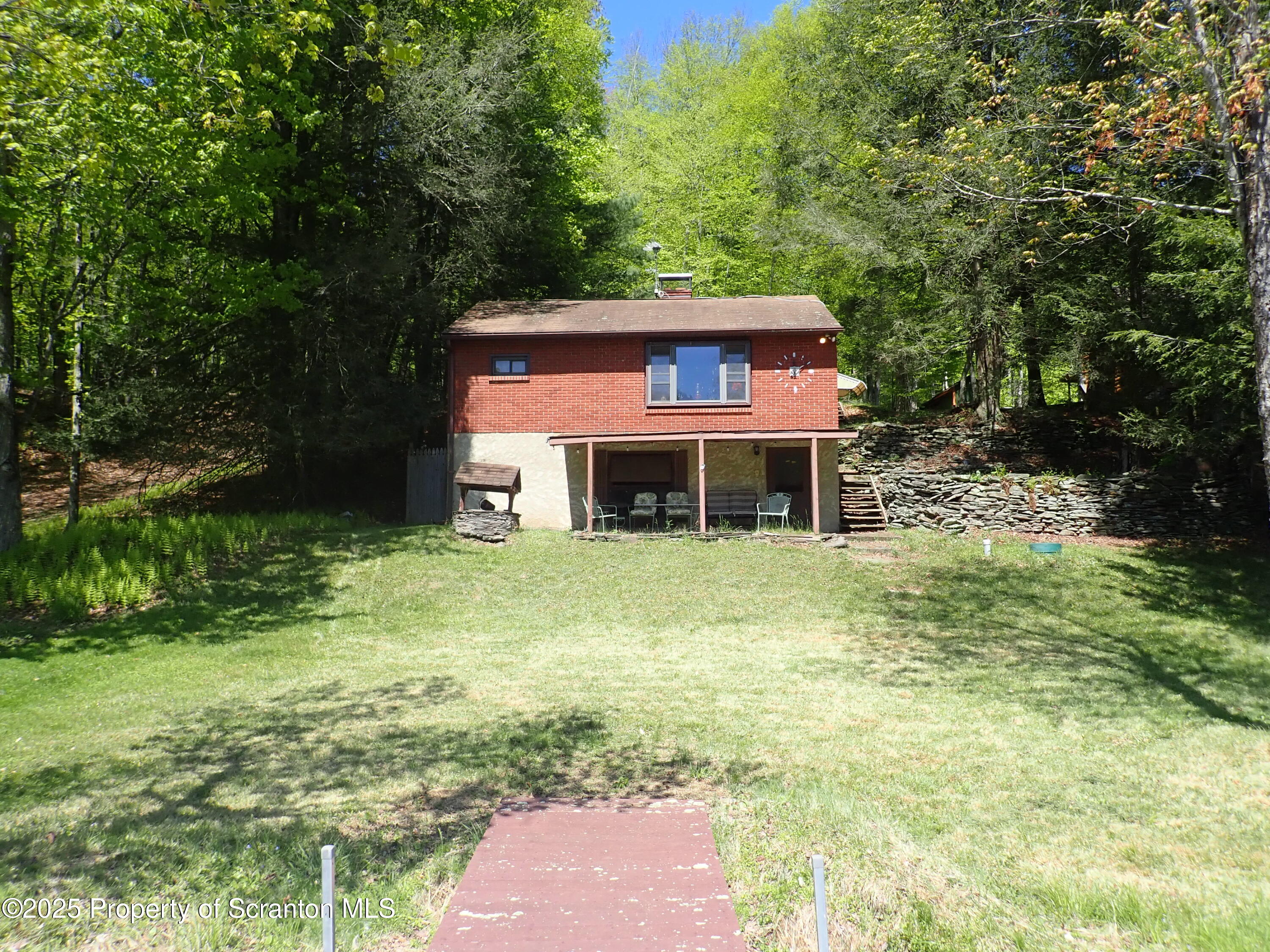 430 Crescent Lake Road Meshoppen, PA 18630 - Photo 1 of 51 a brick house with a big yard