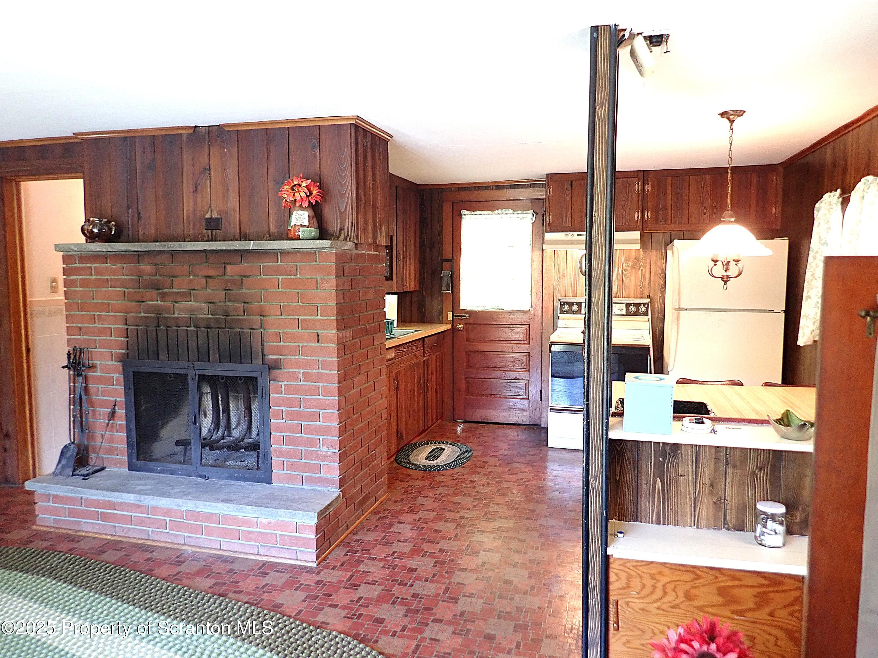 430 Crescent Lake Road Meshoppen, PA 18630 - Photo 20 of 51 a kitchen with kitchen island granite countertop wooden cabinets a stove and a sink