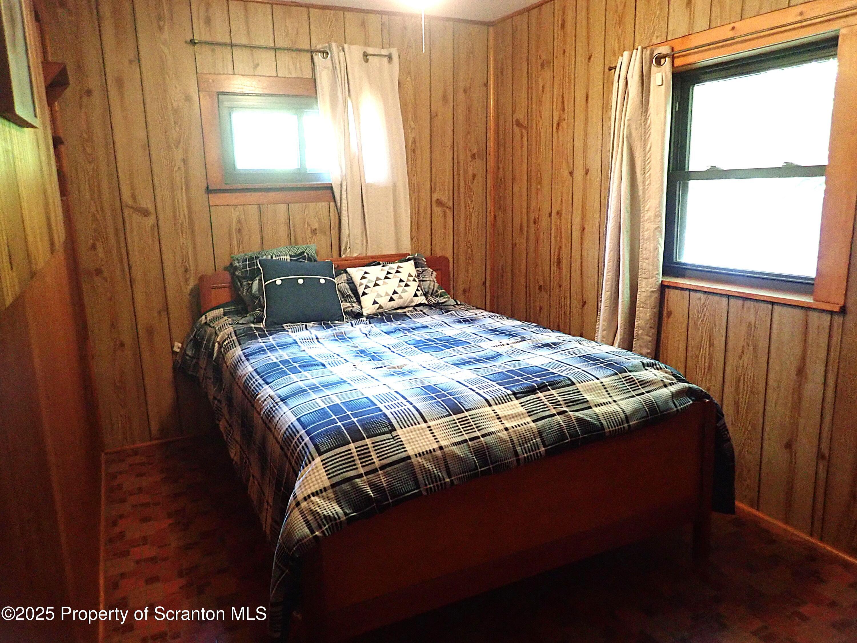 430 Crescent Lake Road Meshoppen, PA 18630 - Photo 29 of 51 a bed sitting in a bedroom next to a window