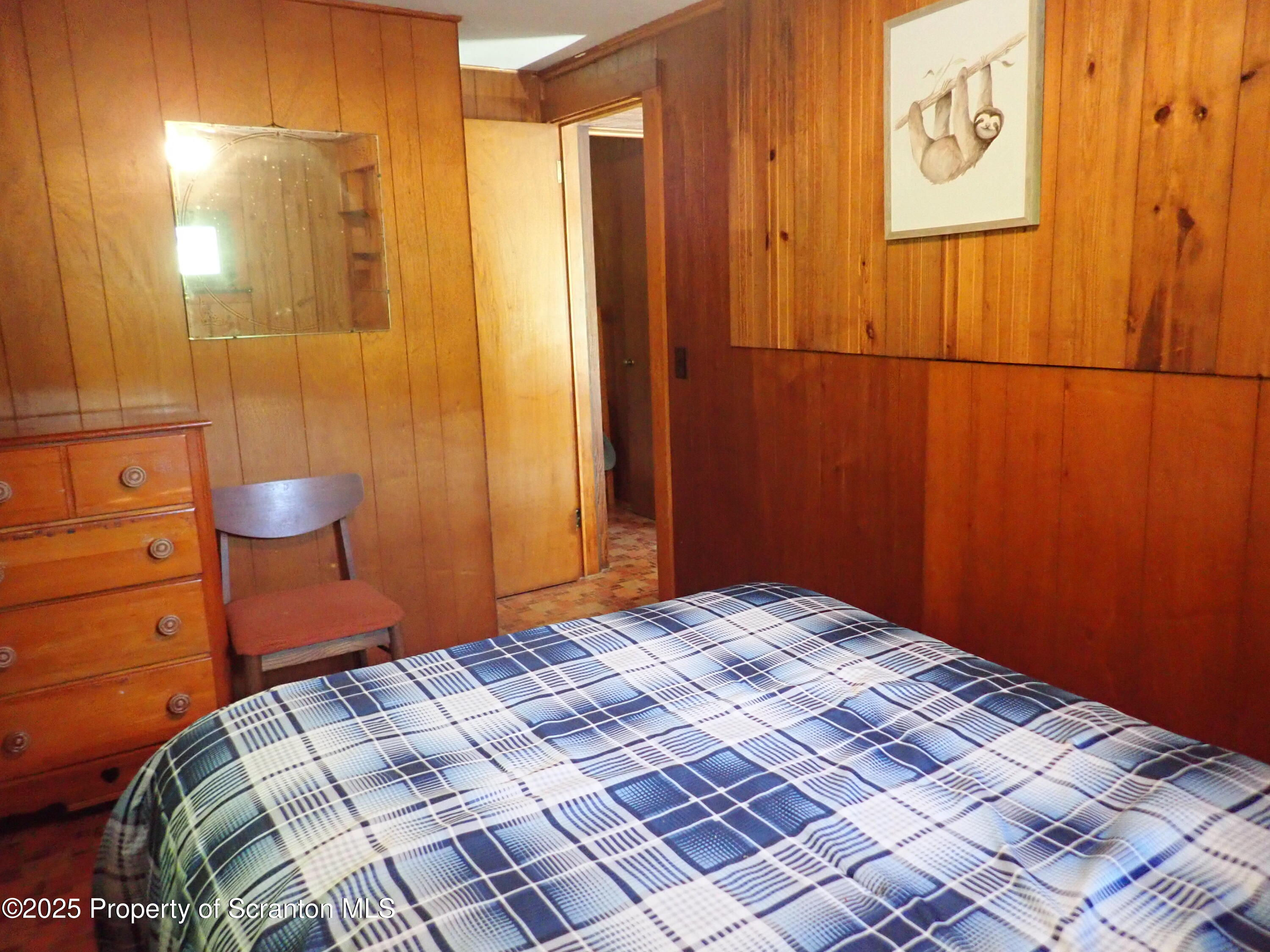430 Crescent Lake Road Meshoppen, PA 18630 - Photo 30 of 51 a bedroom with a bed and a mirror