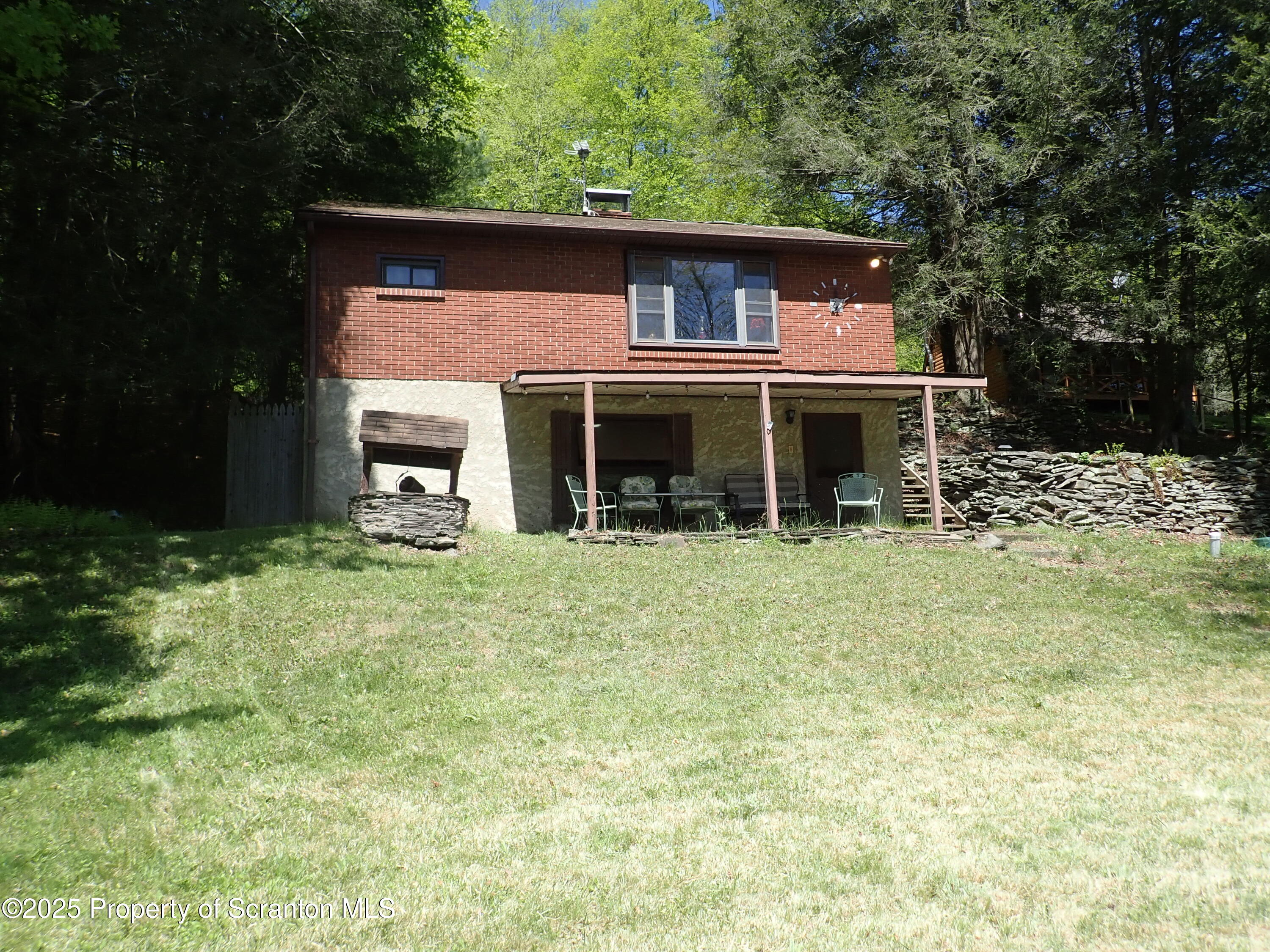 430 Crescent Lake Road Meshoppen, PA 18630 - Photo 3 of 51 a front view of a house with a yard