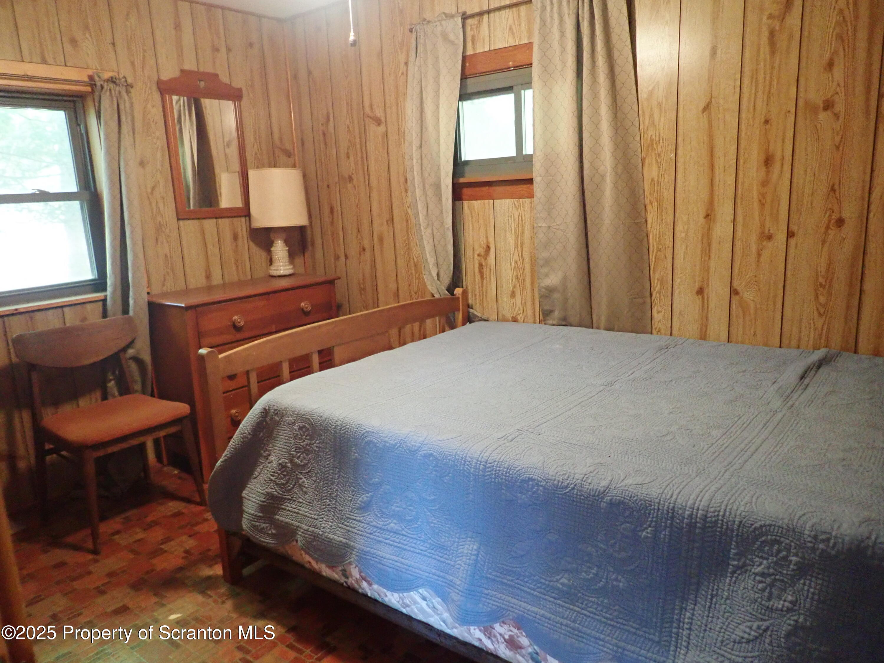 430 Crescent Lake Road Meshoppen, PA 18630 - Photo 31 of 51 a bedroom with a bed and a window