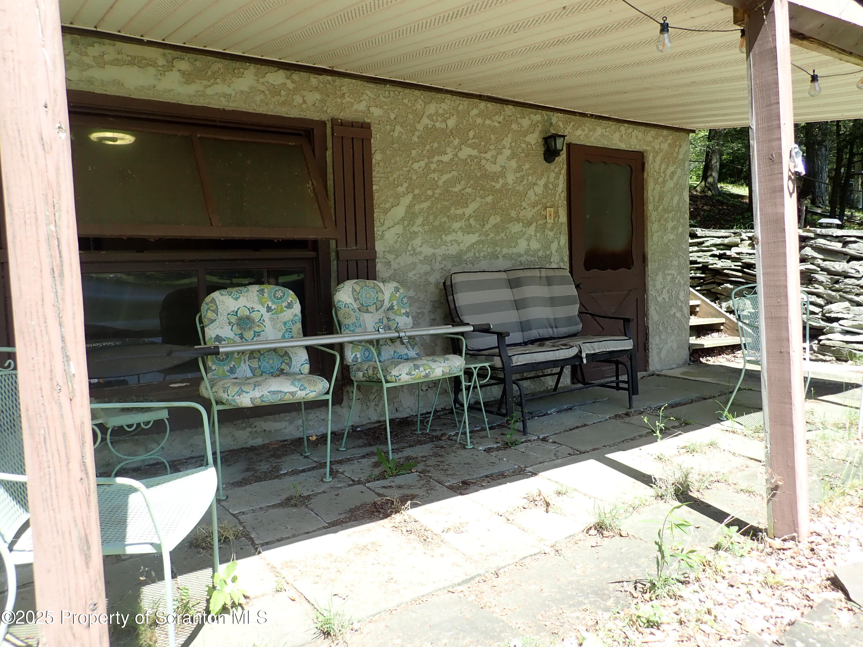 430 Crescent Lake Road Meshoppen, PA 18630 - Photo 41 of 51 a backyard of a house with dining table and chairs