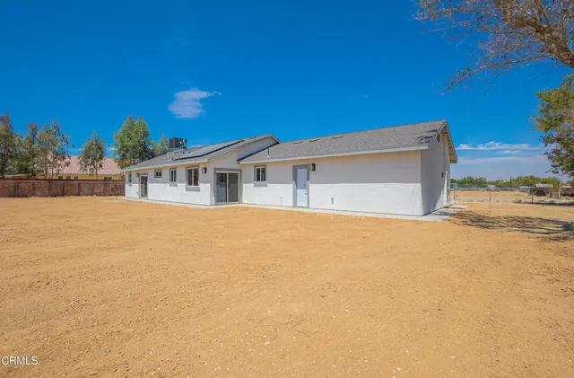 an aerial view of a house with a yard and lake view