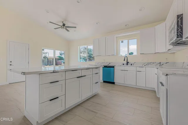 a kitchen with sink cabinets and window