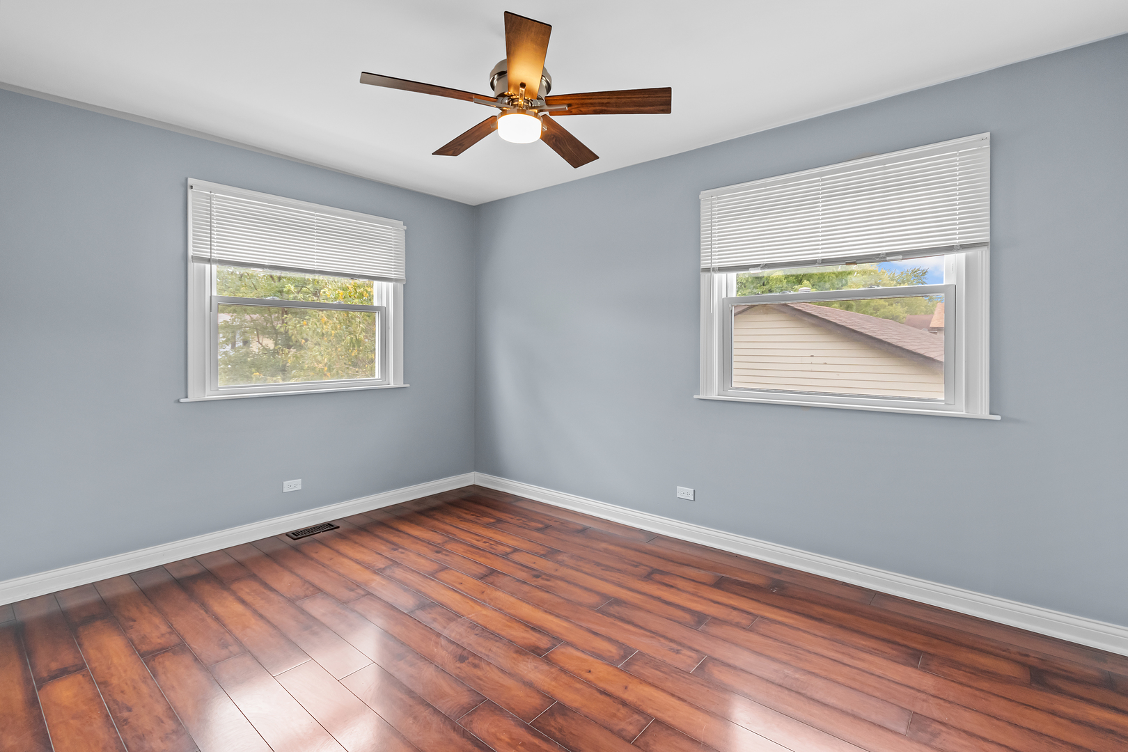 5855 Timberlane Road Matteson, IL 60443 - Photo 10 of 22 a view of an empty room with wooden floor and a window