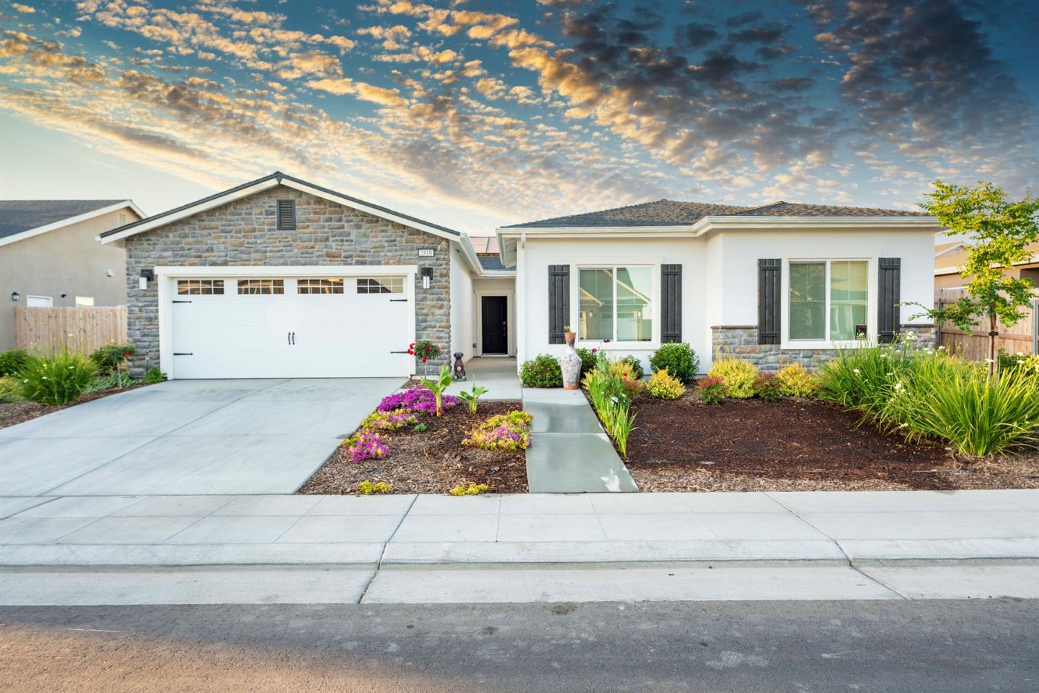 1818 Softwind Drive Tulare, CA 93274 - Photo 2 of 46 a front view of a house with garage