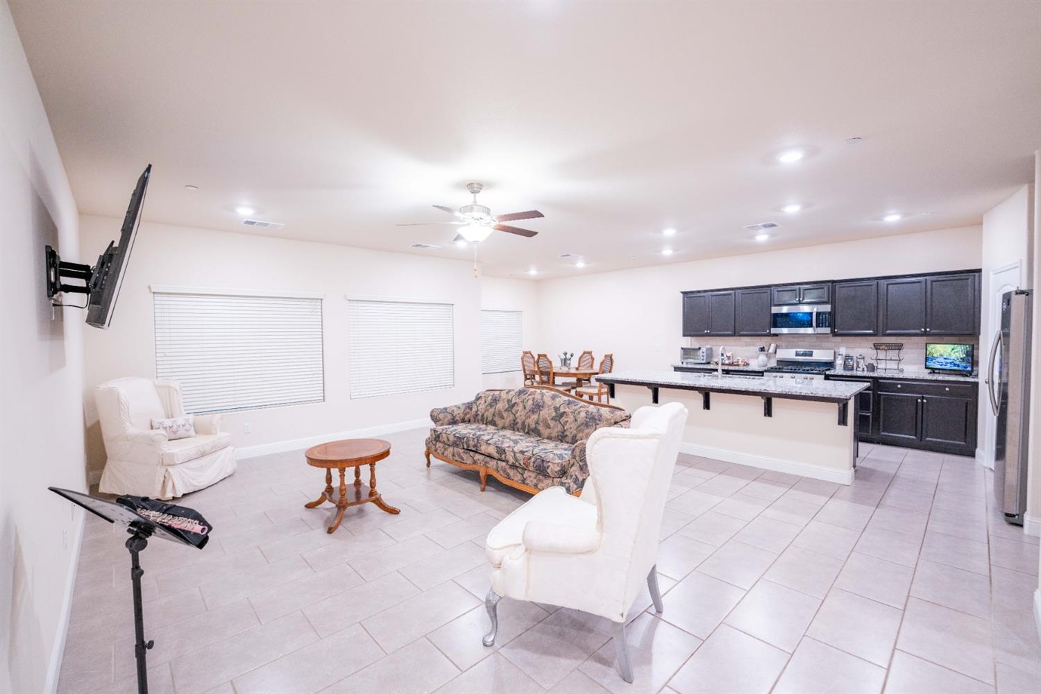 1818 Softwind Drive Tulare, CA 93274 - Photo 15 of 46 a large white kitchen with a large window and kitchen view