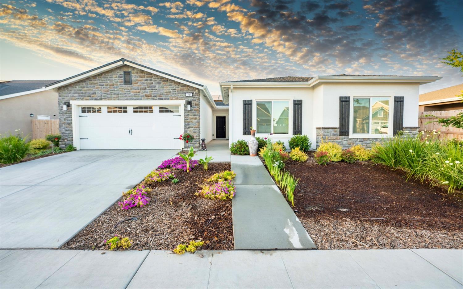 1818 Softwind Drive Tulare, CA 93274 - Photo 3 of 46 a front view of a house with a yard and potted plants