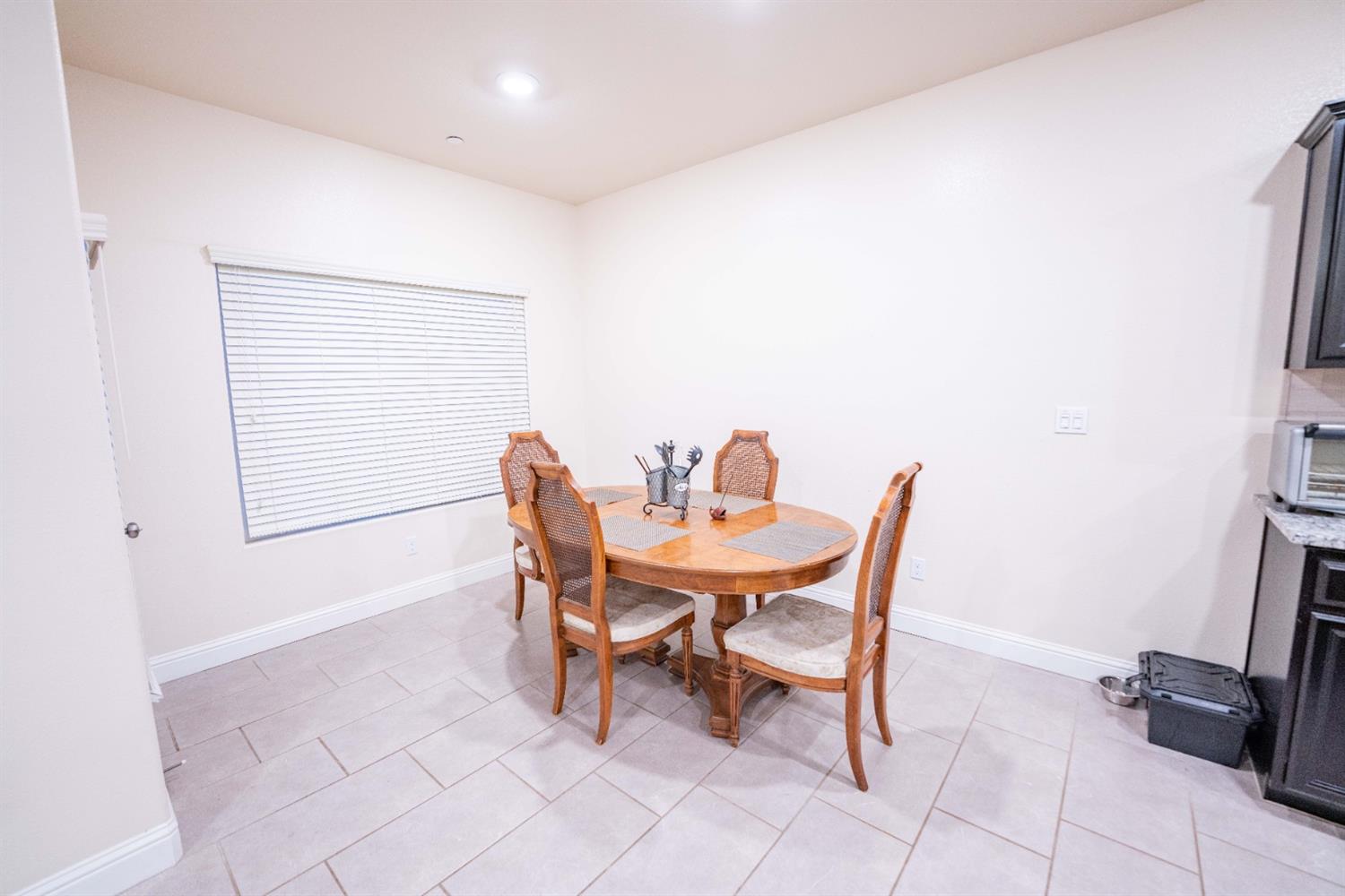 1818 Softwind Drive Tulare, CA 93274 - Photo 21 of 46 a dining room with furniture and a window