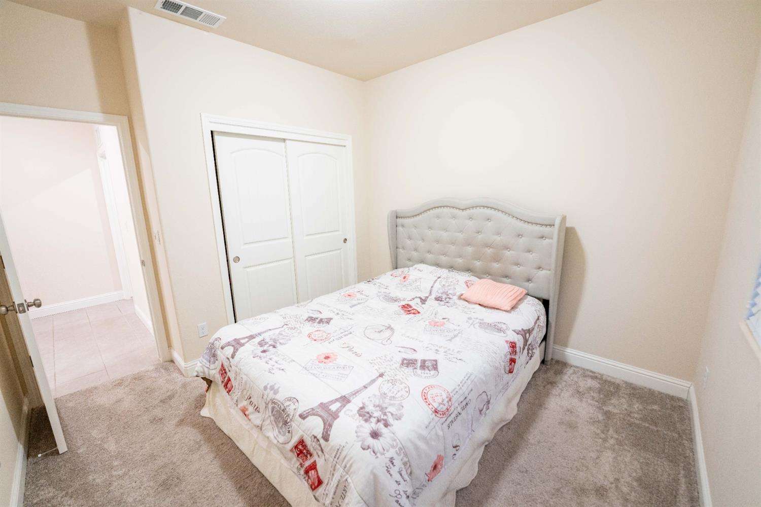 1818 Softwind Drive Tulare, CA 93274 - Photo 25 of 46 a bedroom with a bed and a mirror