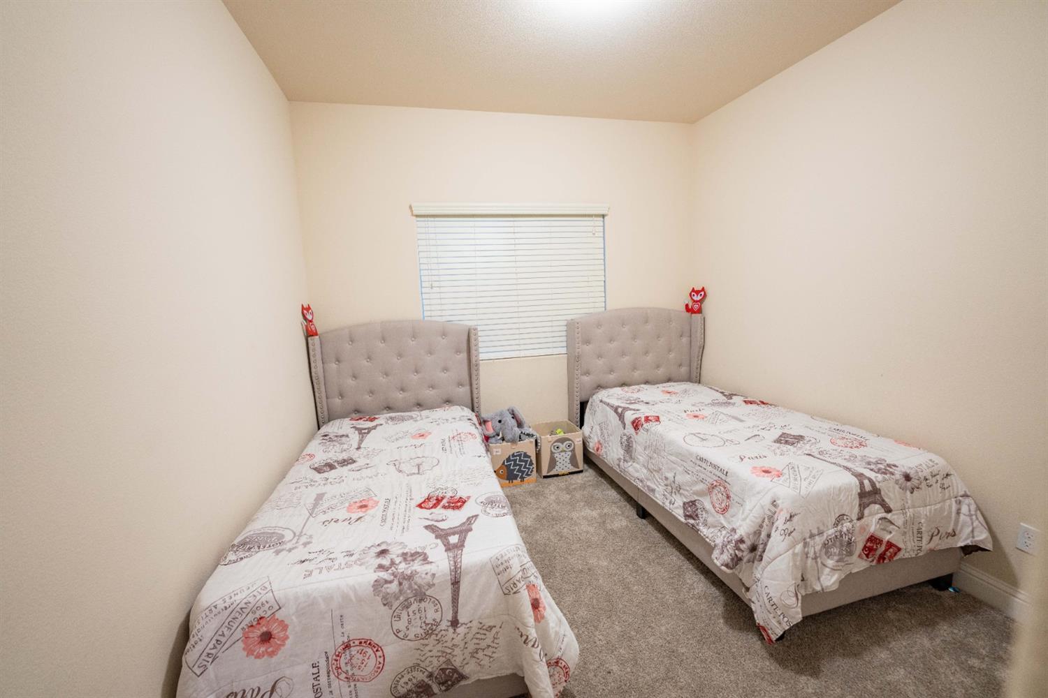 1818 Softwind Drive Tulare, CA 93274 - Photo 28 of 46 a bedroom with two beds and a window