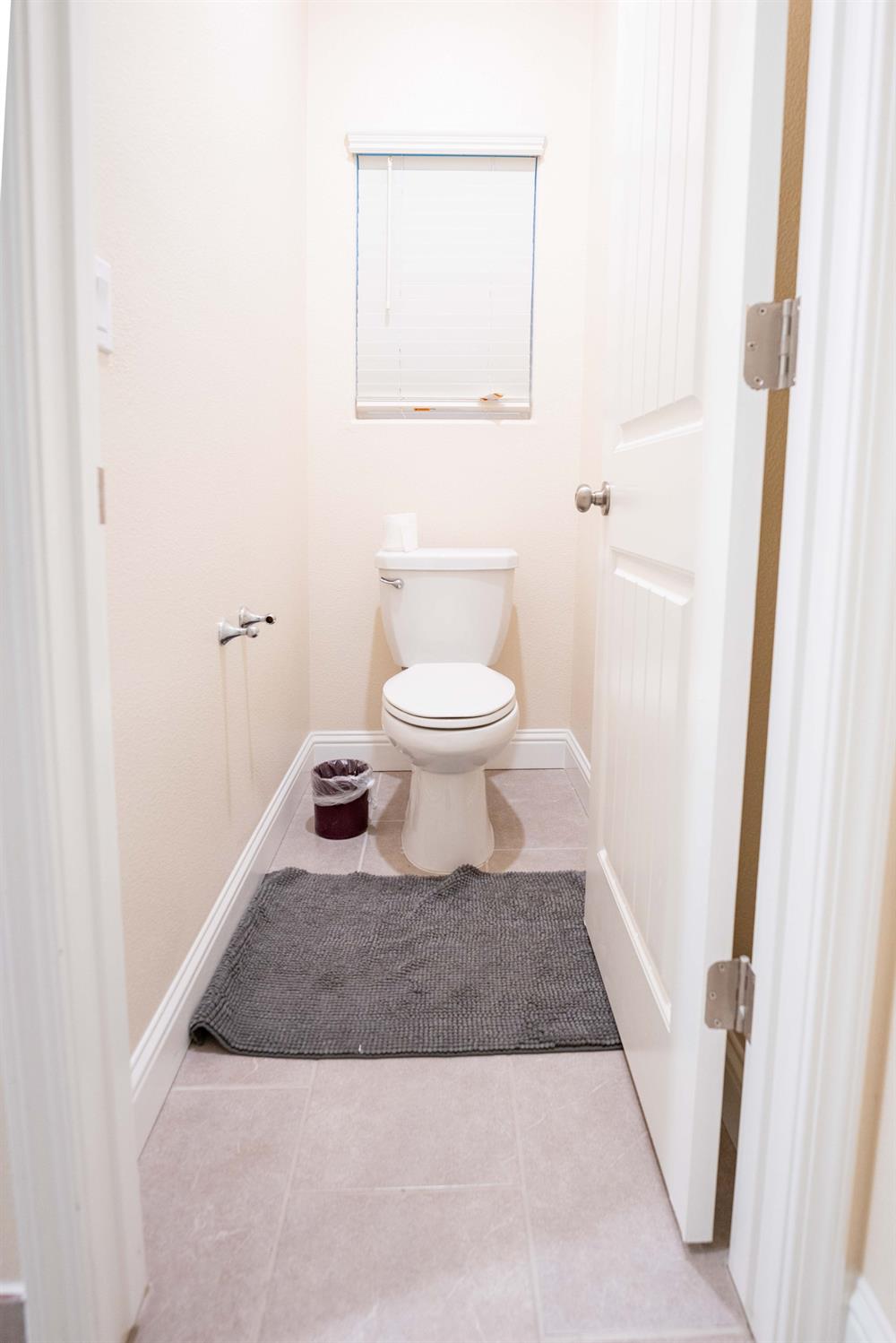 1818 Softwind Drive Tulare, CA 93274 - Photo 34 of 46 a bathroom with a granite countertop toilet and a sink