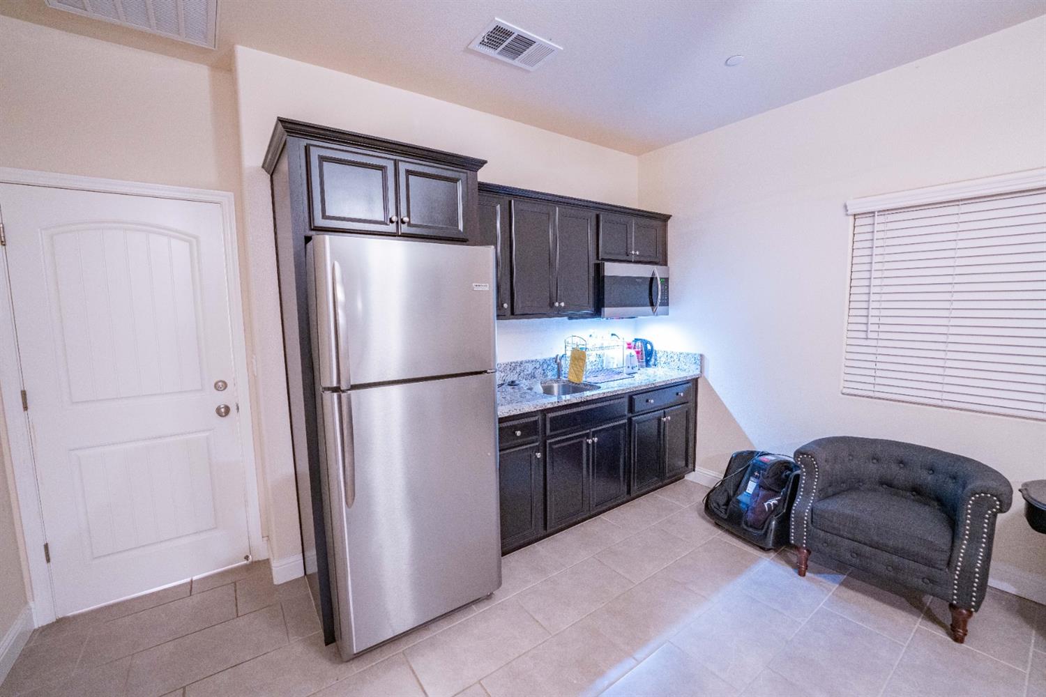 1818 Softwind Drive Tulare, CA 93274 - Photo 37 of 46 a kitchen with stainless steel appliances granite countertop a refrigerator and a sink