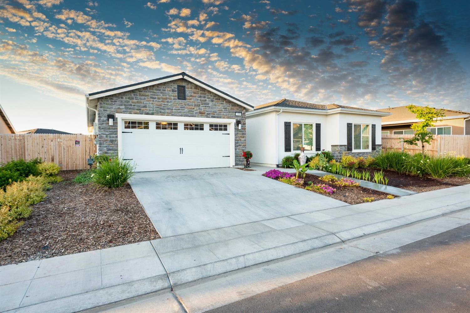 1818 Softwind Drive Tulare, CA 93274 - Photo 5 of 46 a front view of a house with garage and plants