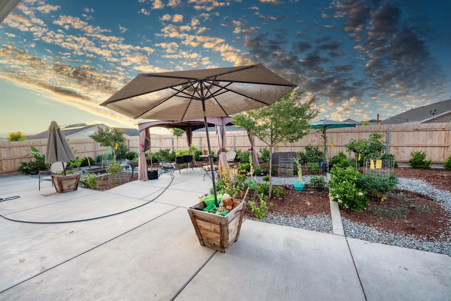 1818 Softwind Drive Tulare, CA 93274 - Photo 42 of 46 a view of a patio with couches and potted plants